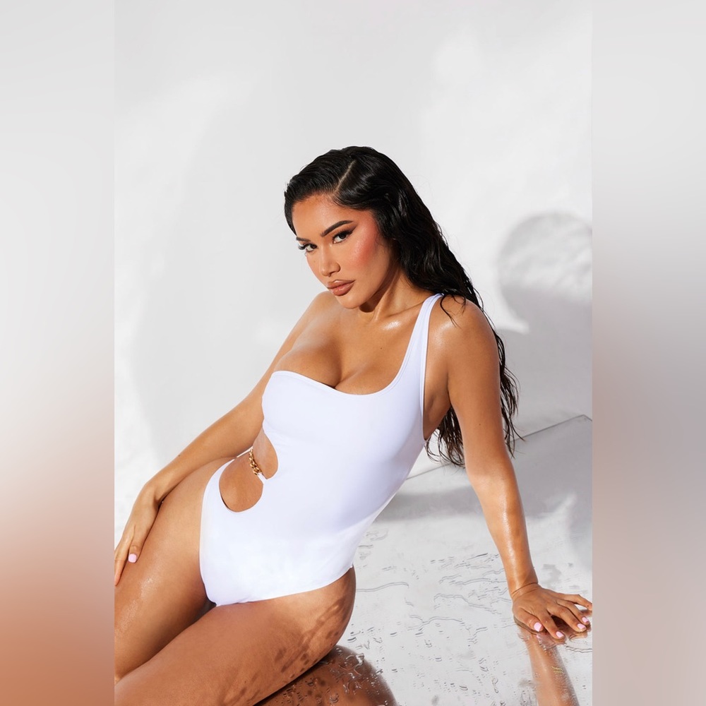 White cutout one piece swimsuit with gold chain detail